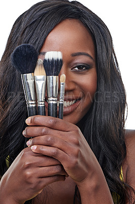 Buy stock photo Studio shot of a young woman holding a makeup brush isolated on white