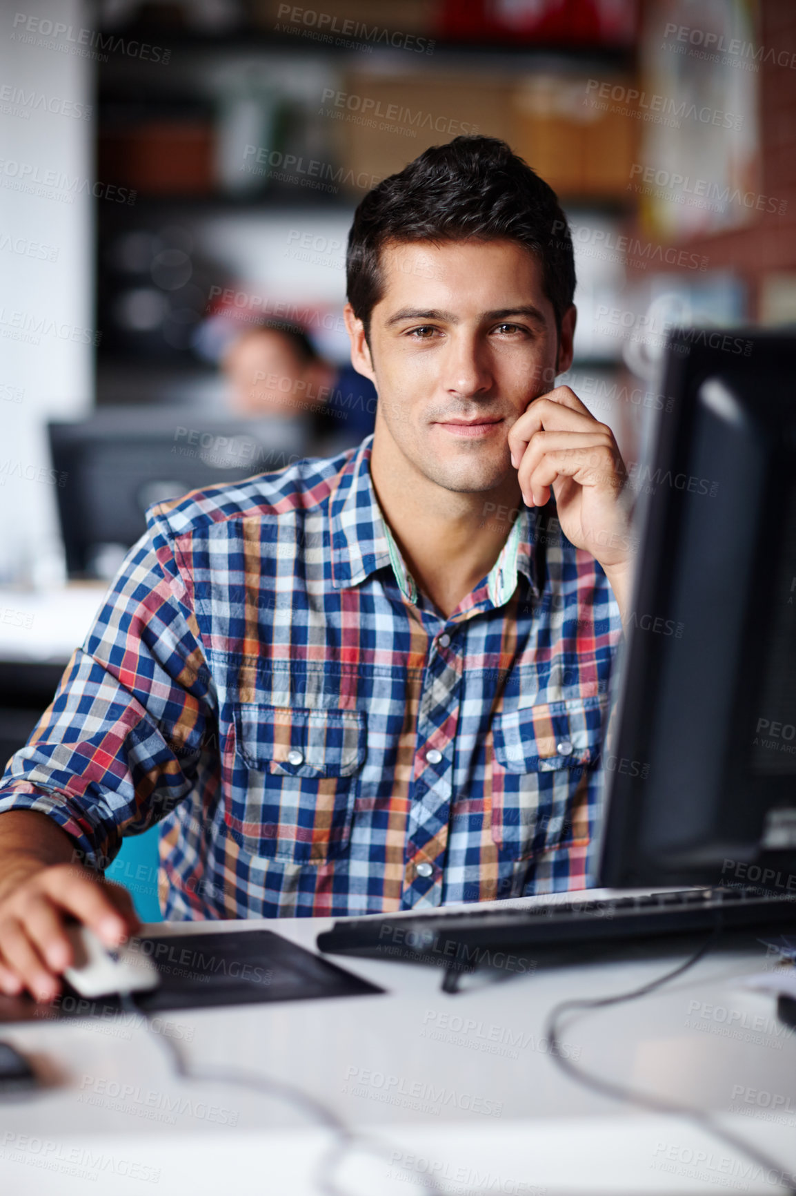 Buy stock photo Portrait of a handsome young designer sitting at his desk in the office