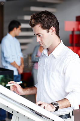 Buy stock photo A young architect trying to improve his designs