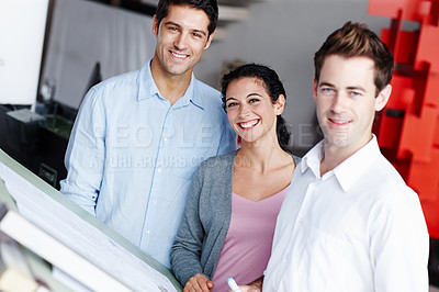 Buy stock photo Portrait of three talented architects working on their design blueprints together
