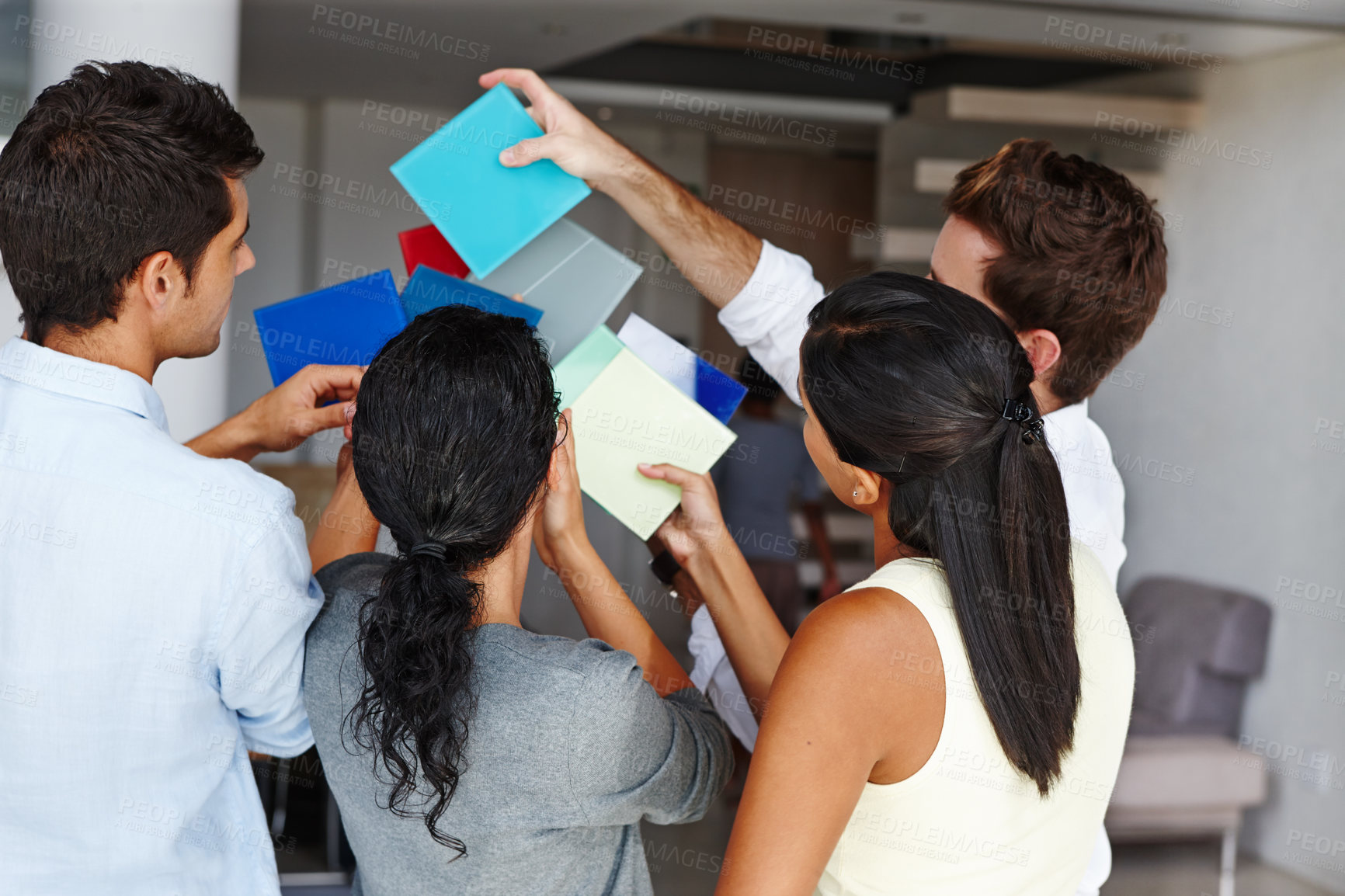 Buy stock photo A team of creative colleagues trying to decide on a colour scheme for a project