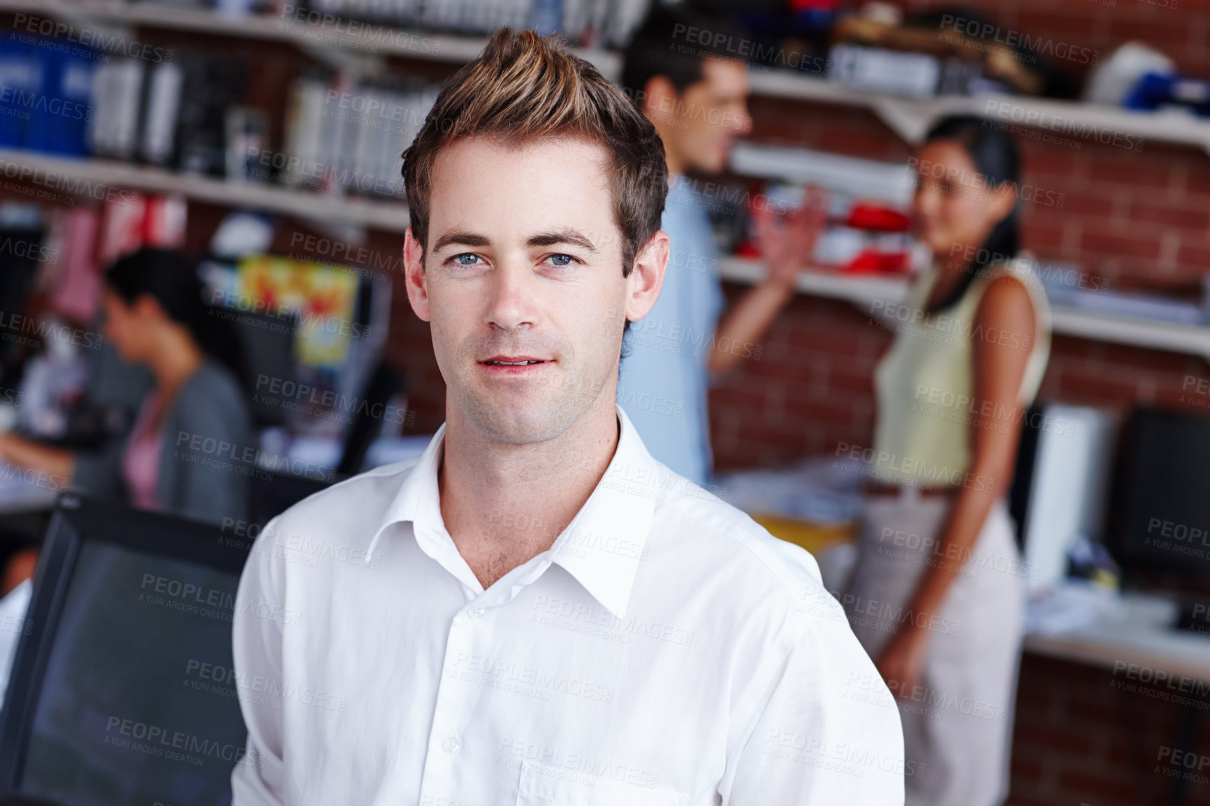 Buy stock photo Portrait of a confident young businessman and his colleagues blurred in the background