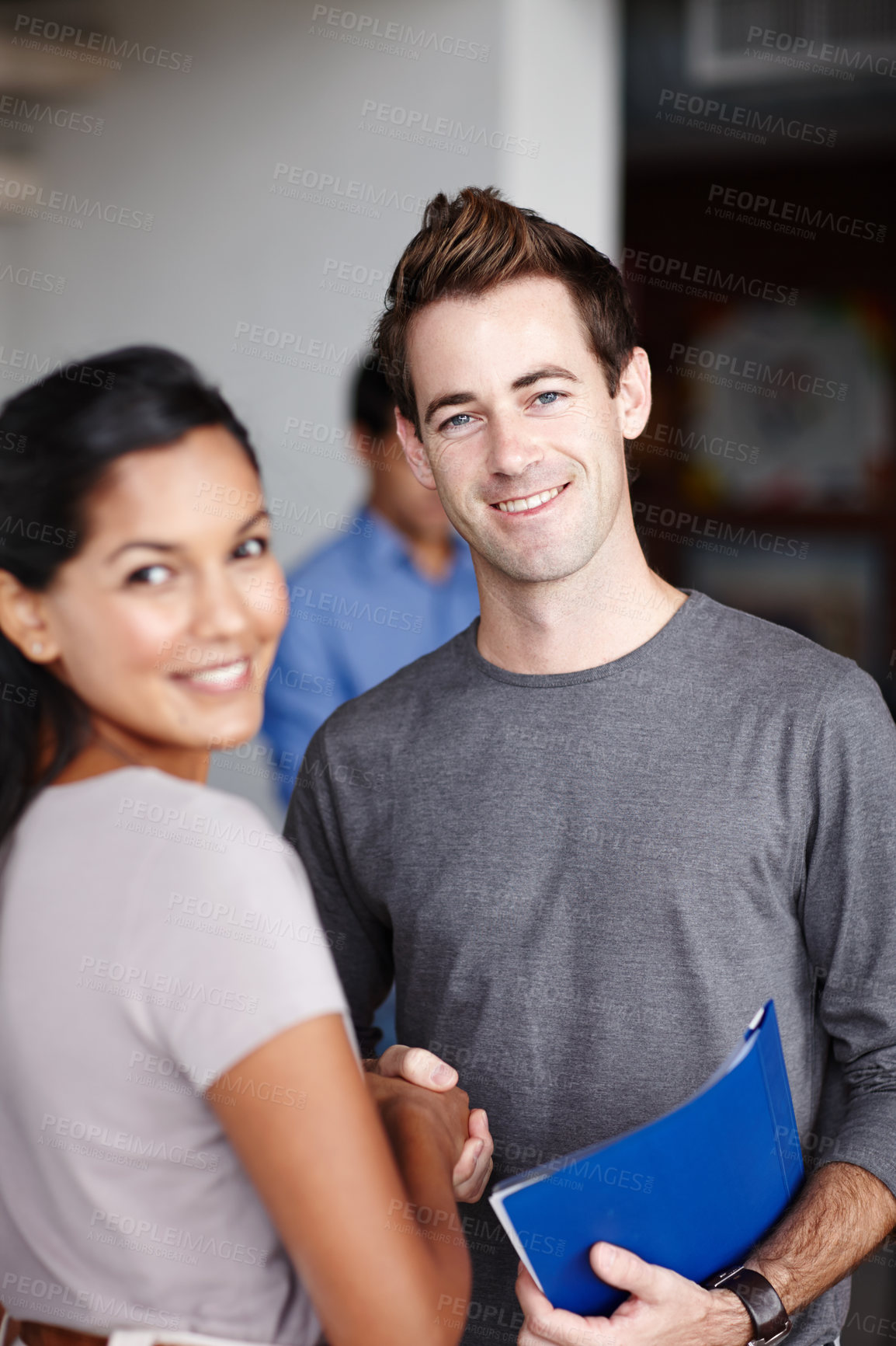 Buy stock photo Portrait of a handsome young businessman shaking hands with his pretty colleague