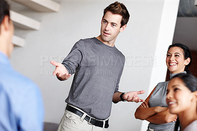 Buy stock photo A young business creative presenting to his colleagues in the boardroom