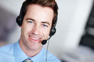 Buy stock photo Closeup portrait of a handsome young call center agent smiling along side copyspace