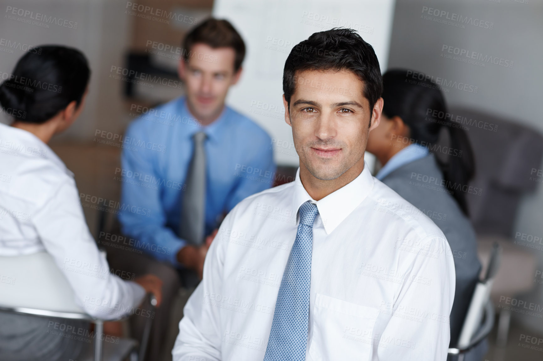 Buy stock photo A handsome executive smiling at you confidently during a business presentation