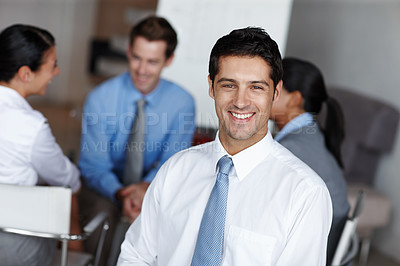 Buy stock photo A handsome executive smiling at you confidently during a business presentation