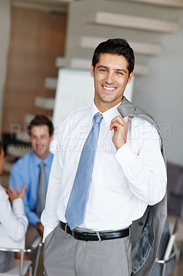 Buy stock photo Portrait of a handsome young businessman with his suit jacket over his shoulders