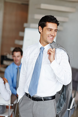 Buy stock photo A handsome young businessman with his suit jacket over his shoulders