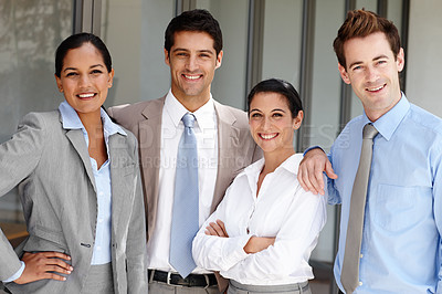 Buy stock photo Four confident businesspeople standing together unified
