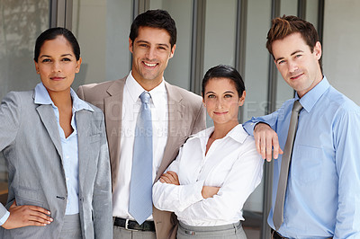 Buy stock photo Four confident businesspeople standing together unified