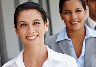 Buy stock photo Head and shoulders portrait of a pretty young woman smiling at you confidently