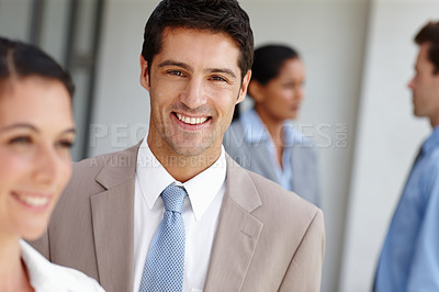 Buy stock photo A confident businessman standing with colleagues after a successful business pitch
