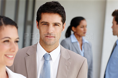 Buy stock photo A seriou businessman standing with colleagues before an important meeting