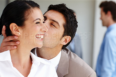 Buy stock photo A delighted businesswoman receiving a congratulatory kiss on the cheek after a successful pitch