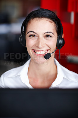 Buy stock photo Portrait of a pretty call center agent wearing a headset and sitting in front of her computer