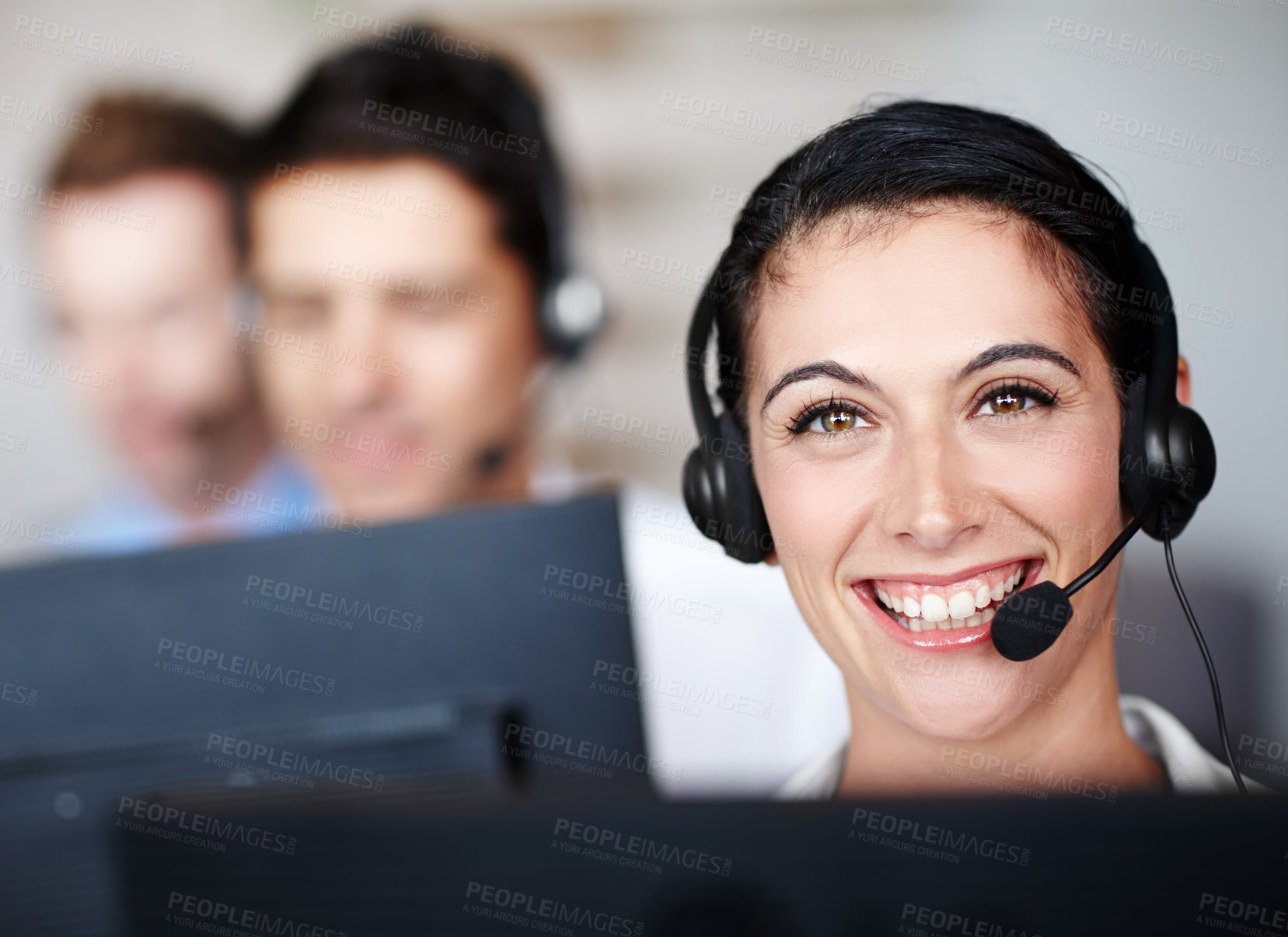 Buy stock photo Portrait of a pretty call center agent wearing a headset and sitting in front of her computer