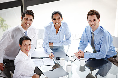 Buy stock photo Portrait of a group of successful businesspeople sitting at the boardroom table