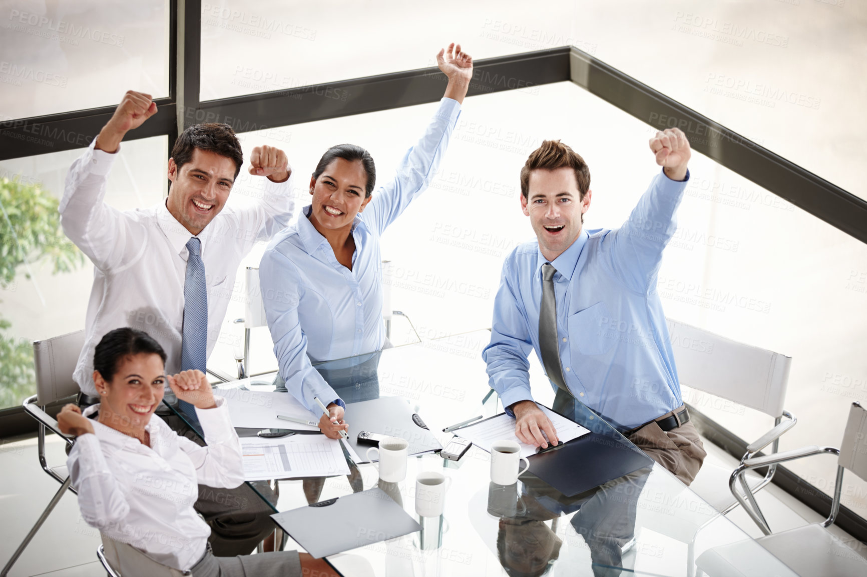 Buy stock photo A group of excited businesspeople celebrating their success in the boardroom