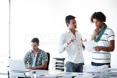 Buy stock photo Three male coworkers working in the office together