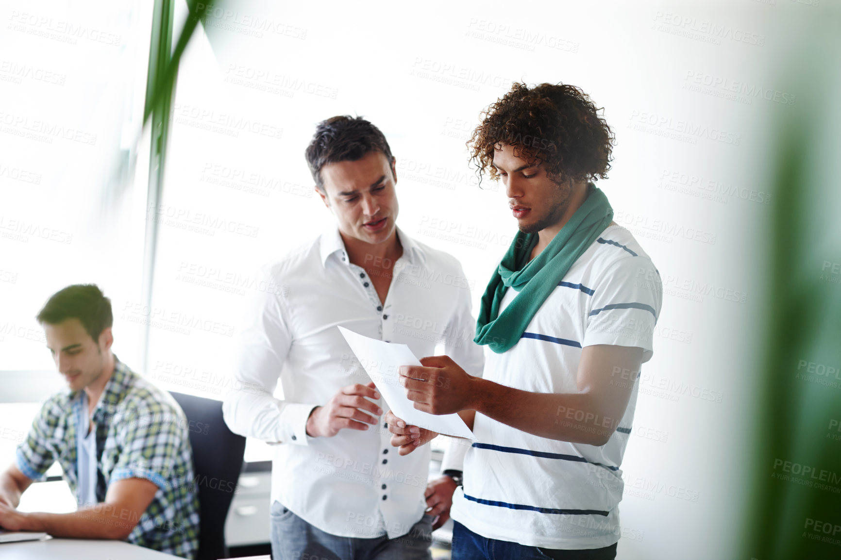 Buy stock photo Three male coworkers working in the office together