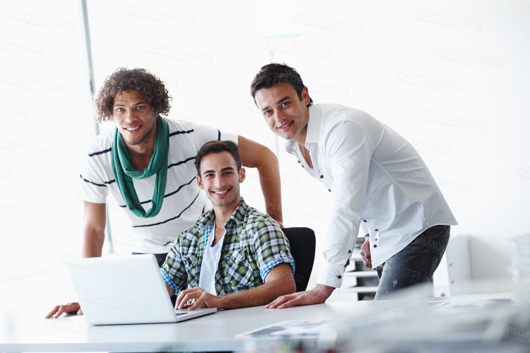 Buy stock photo Three male coworkers working in the office together