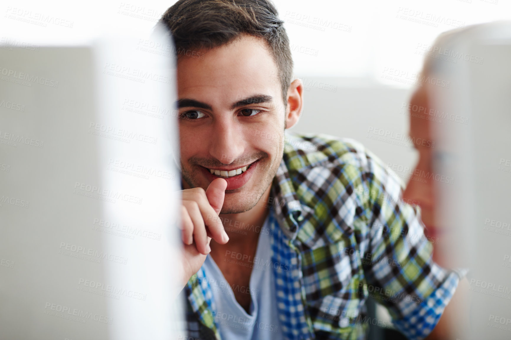 Buy stock photo Young male and female nerdy employees work as a team on a computer, collaborating showing unity and teamwork. Coming up with creative and innovative ideas to maximize business opportunities