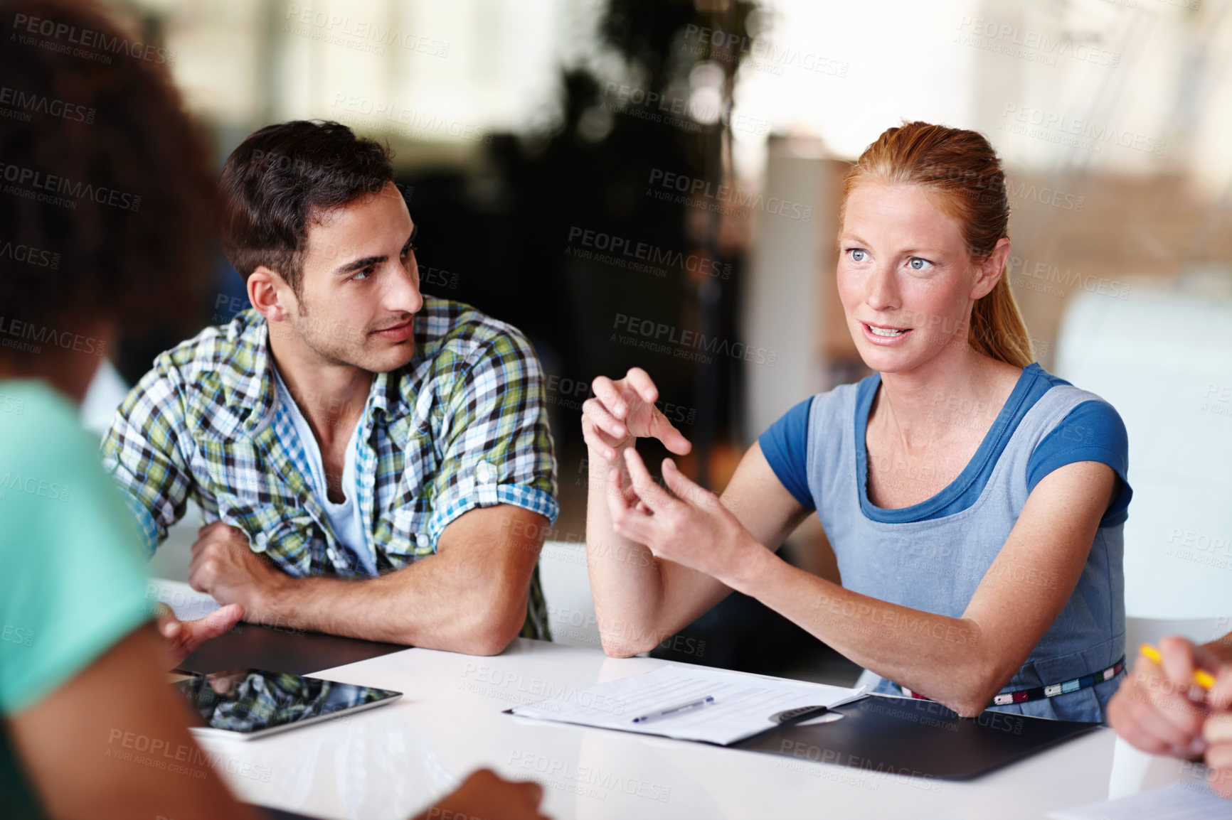 Buy stock photo Young colleagues having a meeting in the office