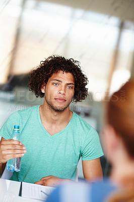 Buy stock photo Young colleagues having a meeting in the office