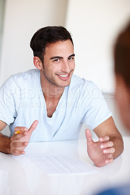 Buy stock photo Young colleagues having a meeting in the office