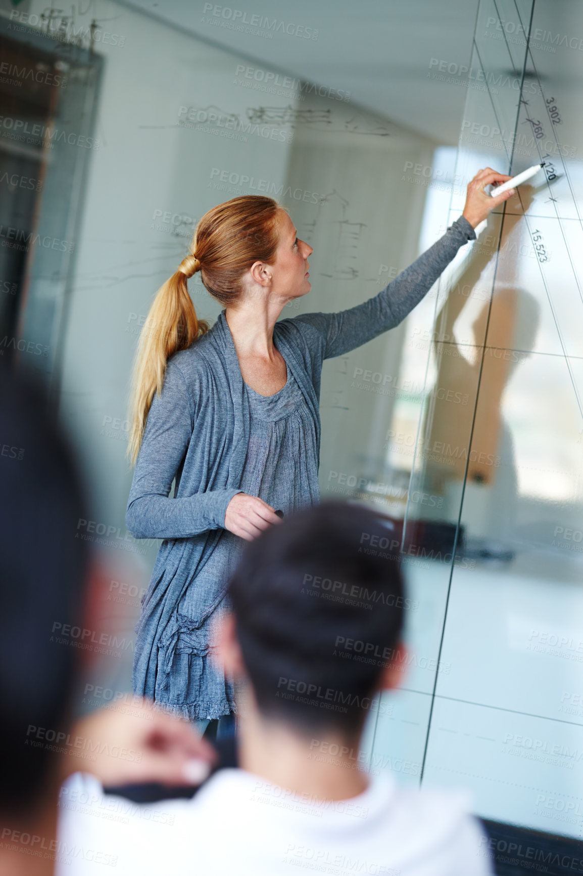 Buy stock photo Woman, team and writing presentation on glass board for training staff on company target or project at office. Young female person or speaker talking to employees for growth, profit or revenue