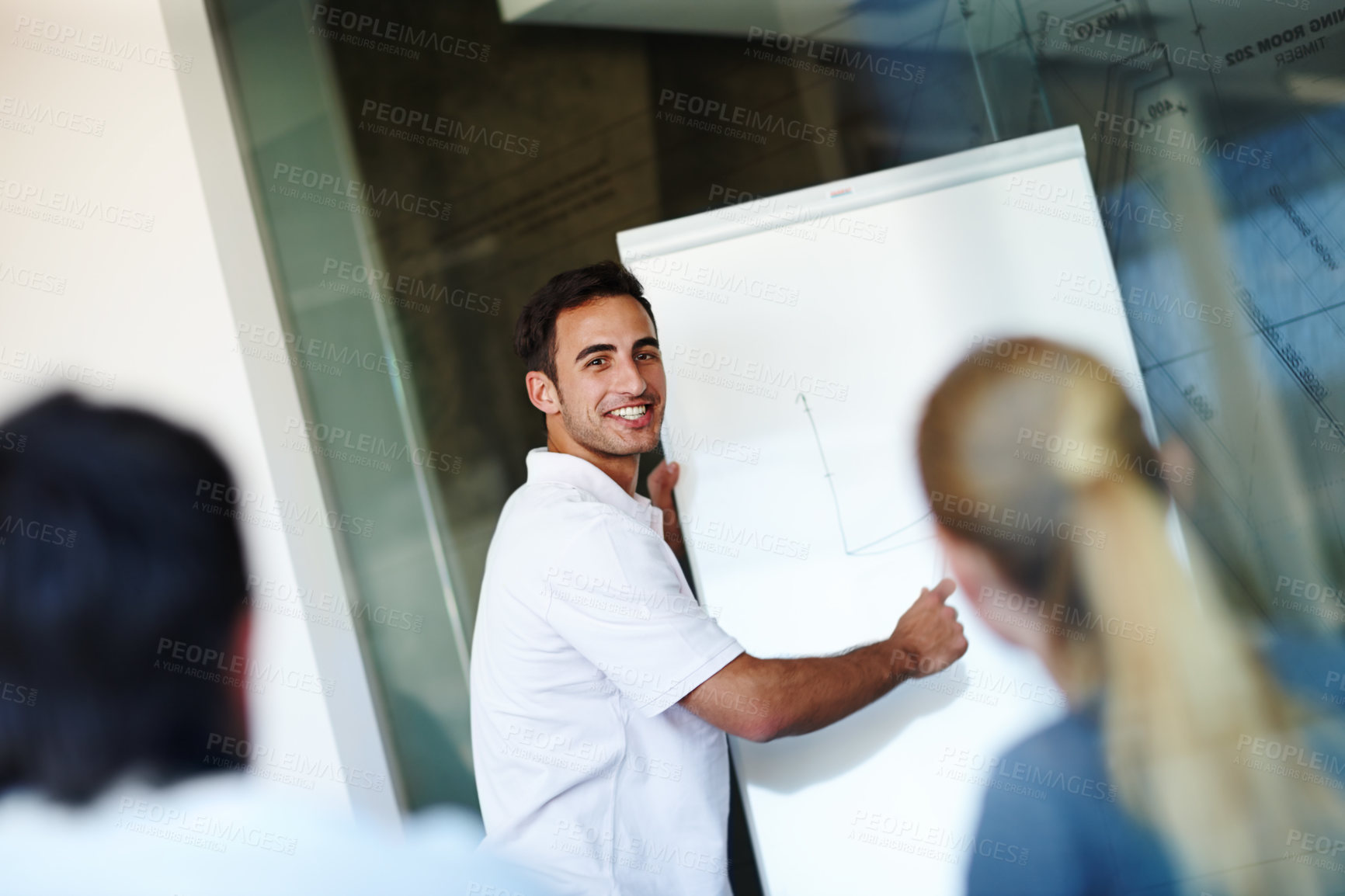 Buy stock photo Happy man, presentation and meeting with whiteboard for project or team discussion at office. Young businessman or speaker talking to employees for company ideas, growth or development at workplace