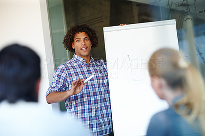 Buy stock photo Happy man, presentation and meeting with whiteboard for team discussion on project together at office. Young businessman or speaker talking to employees for company ideas, growth or graph on revenue