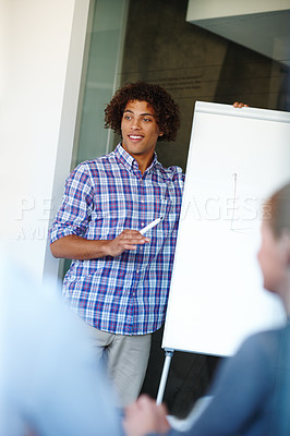 Buy stock photo Casual young businessman giving a presentation using a whiteboard