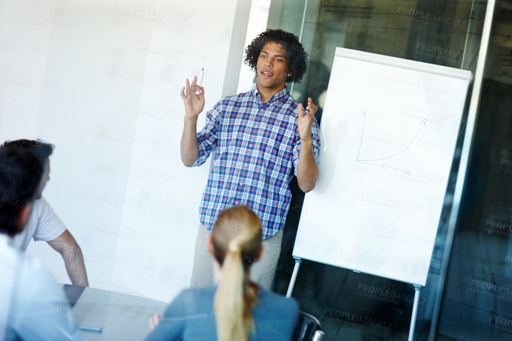 Buy stock photo Businessman, presentation and meeting with whiteboard or chart for team discussion on project at office. Young man or speaker explaining company growth, revenue or profit to employees at workplace