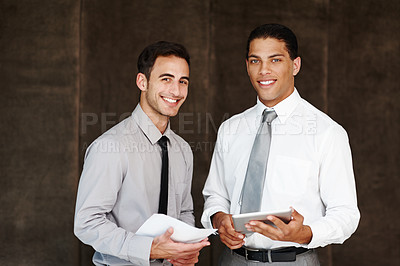 Buy stock photo Two professional businessmen having a discussion using a digital tablet