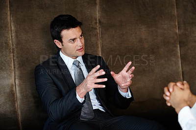 Buy stock photo Handsome young businessman conducting a consultation during a meeting