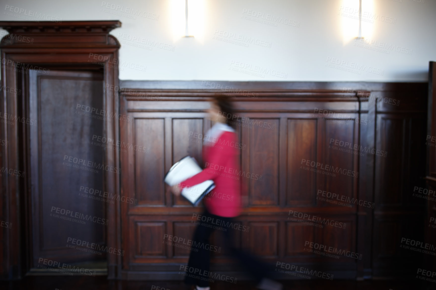 Buy stock photo Side view of a female legal person walking quickly with some documents