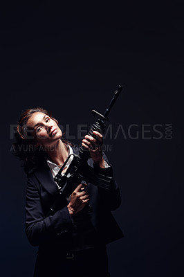 Buy stock photo Woman, portrait and suit with rifle in studio for business security and company protection on black background. Female person, mockup and gun for corporate crime, corruption and white collar criminal
