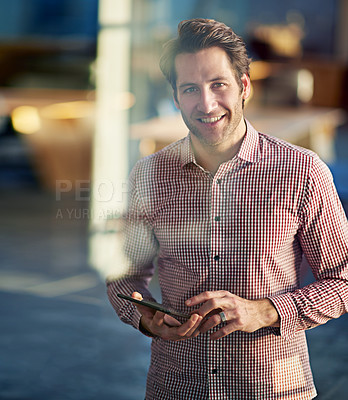 Buy stock photo Shot of a man holding a digital tablet while working in an office