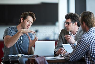 Buy stock photo Cropped shot of three businessman discussing work in the office