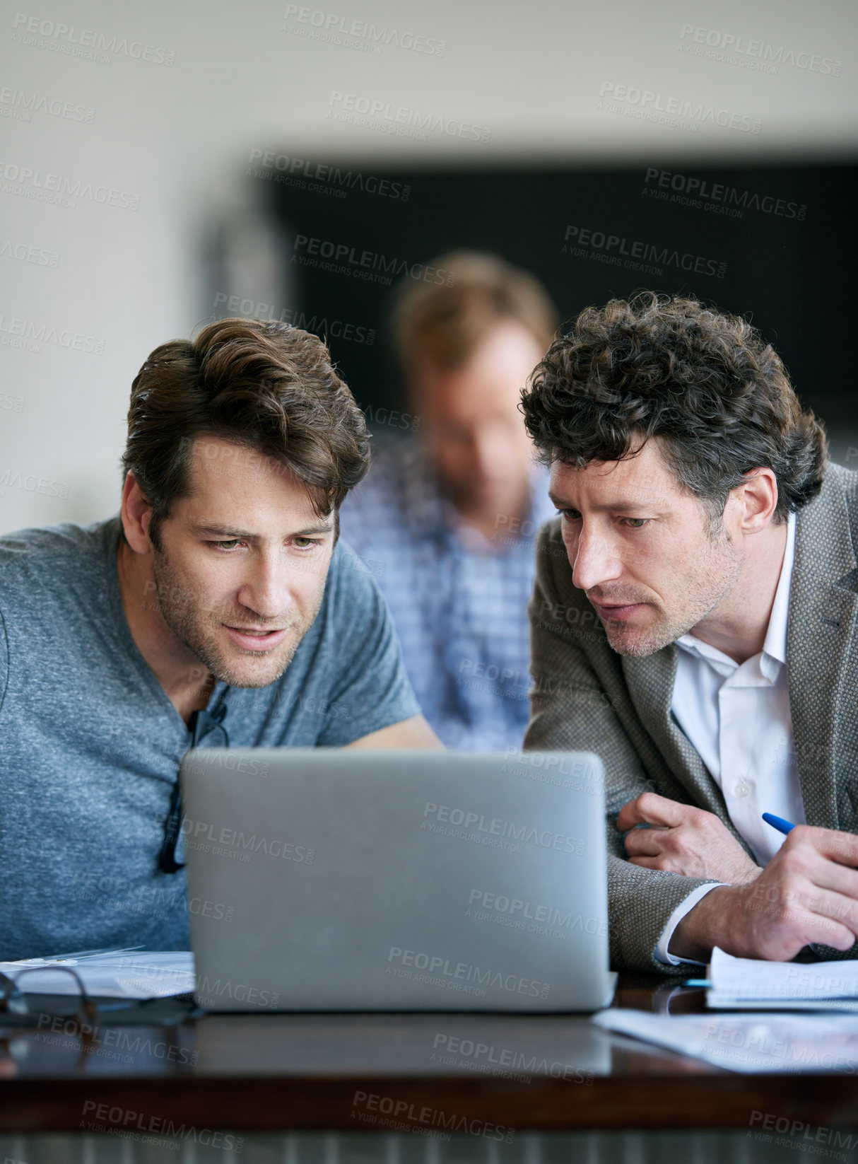 Buy stock photo Colleagues, laptop and working for company in office for conversation or discussion. Businessmen, workers and technology with paperwork or documents in workplace for corporate, meeting or review