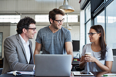 Buy stock photo Cropped shot of three businesspeople discussing work in the office