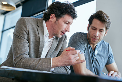 Buy stock photo Cropped shot of two handsome businessmen working in the office