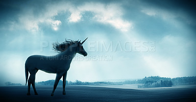 Buy stock photo Shot of a beautiful unicorn against against a dramatic landscape