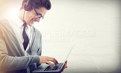 Buy stock photo Happy man, laptop and headphones listening to music or audio streaming on a gray studio background. Male person or employee smile on computer for podcast, social media or networking on mockup space