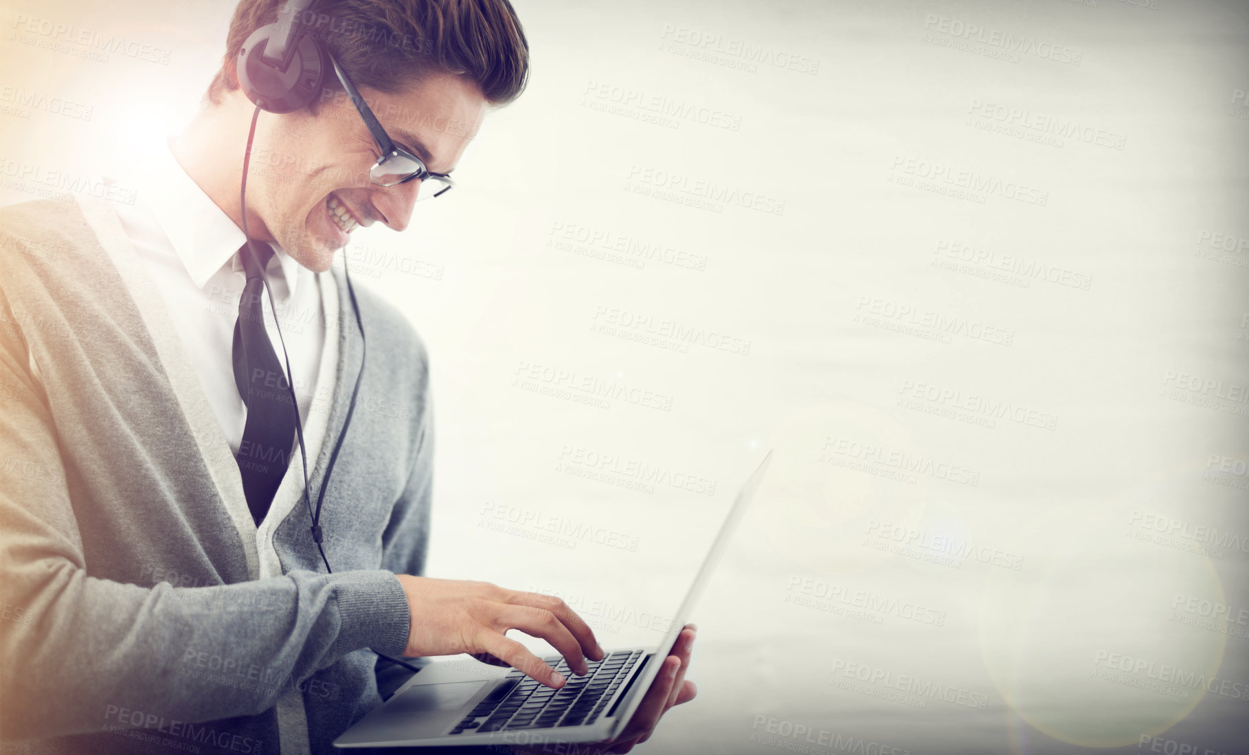 Buy stock photo Happy man, laptop and headphones listening to music or audio streaming on a gray studio background. Male person or employee smile on computer for podcast, social media or networking on mockup space