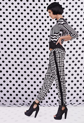 Buy stock photo Studio shot of a retro-stylish young woman against a black and white polka dot background