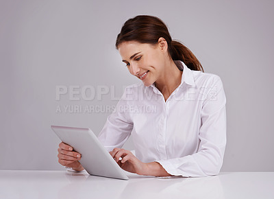 Buy stock photo Tablet, desk and woman with smile, studio and entrepreneur, designer and creative with technology. Background, employee and female person, happiness and online with internet, career and website