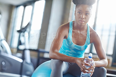 Buy stock photo Relax, water and portrait of black woman on gym ball for fitness, workout pride and confidence in body care. Health, wellness and serious athlete girl with bottle on break at sports club for exercise